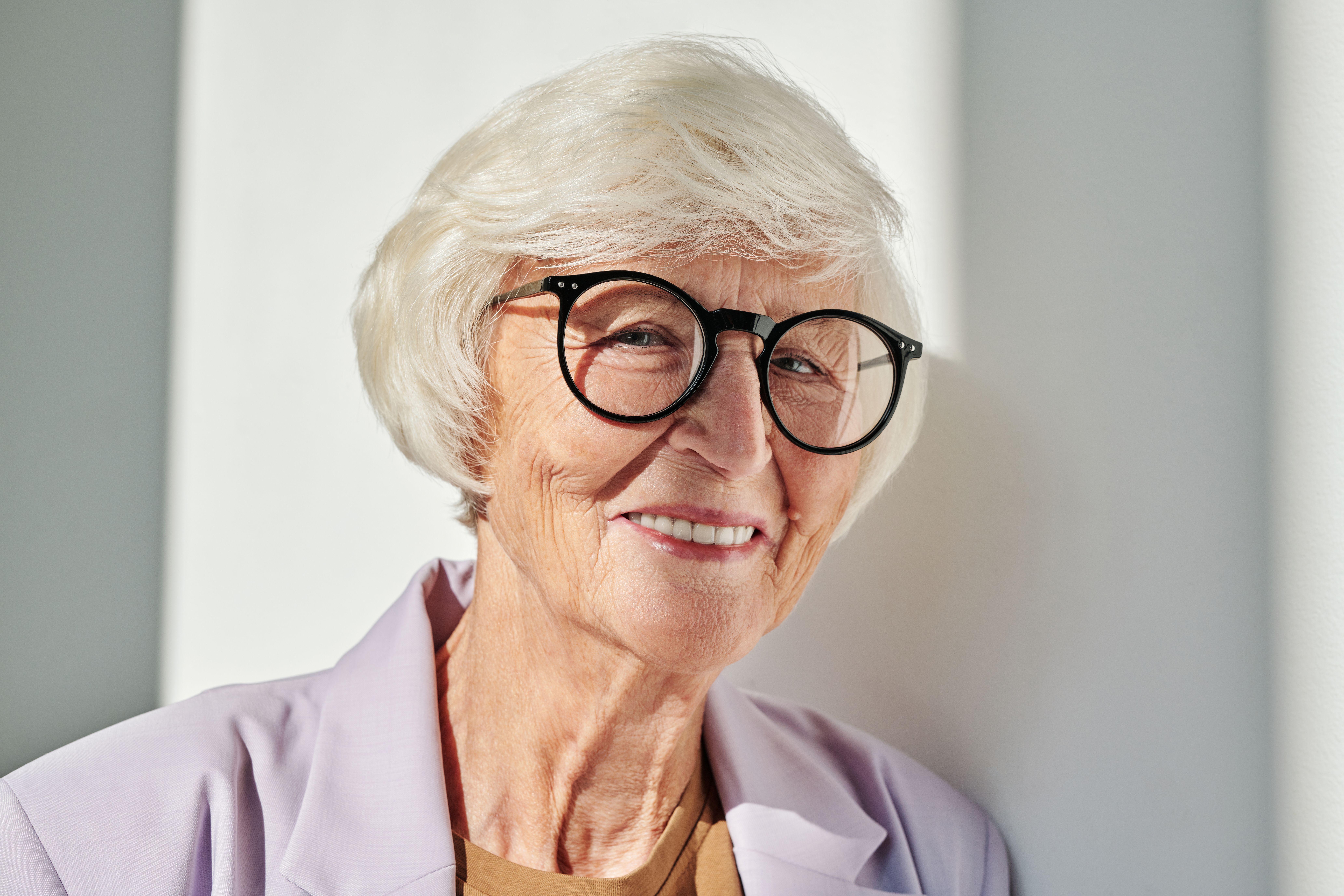 An older woman smiling in natural light